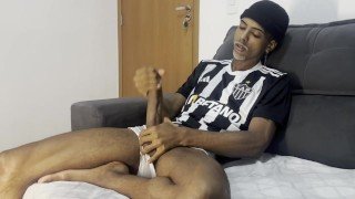 Masturbating his huge cock